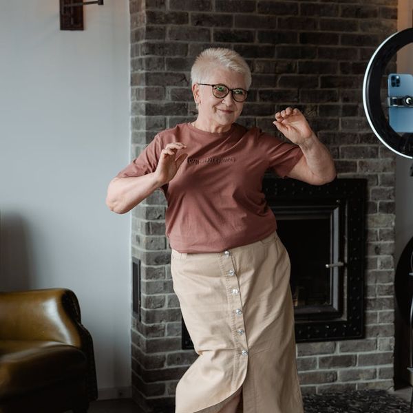 Woman feeling energetic and full of life in a bright space.